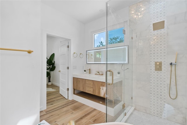 4879 Commonwealth Dr, Sarasota, FL 34242 - bathroom with a shower stall, vanity, and wood finished floors