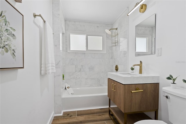 4879 Commonwealth Dr, Sarasota, FL 34242 - full bath featuring healthy amount of natural light, vanity, shower / bathtub combination, and wood finished floors