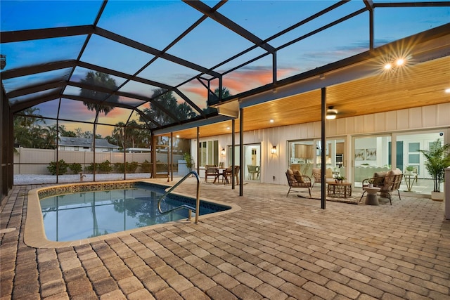 4879 Commonwealth Dr, Sarasota, FL 34242 - pool at dusk featuring a patio area, an outdoor living space, and glass enclosure