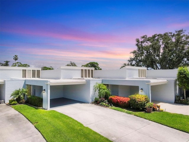 4116 61st Avenue Terrace W, Bradenton, FL 34210 - view of front facade with an attached carport, concrete driveway, and stucco siding
