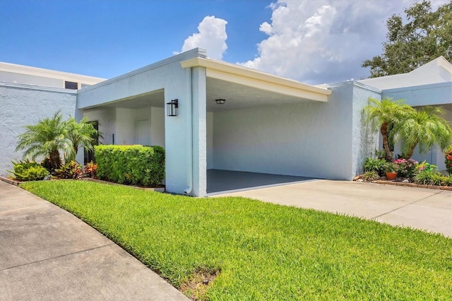 4116 61st Avenue Terrace W, Bradenton, FL 34210 - view of property exterior with a yard, driveway, and stucco siding