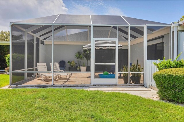 4116 61st Avenue Terrace W, Bradenton, FL 34210 - back of house featuring glass enclosure, a lawn, and a patio area