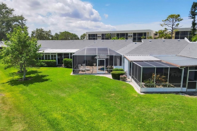 4116 61st Avenue Terrace W, Bradenton, FL 34210 - back of property featuring a yard, a patio area, and glass enclosure