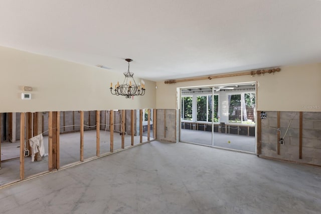 212 71st St, Holmes Beach, FL 34217 - empty room with a chandelier and concrete flooring
