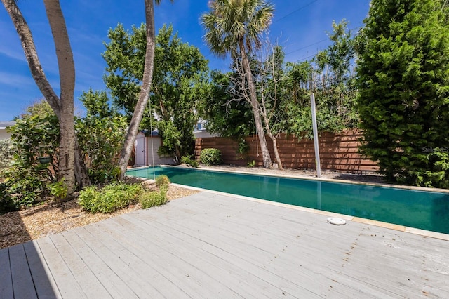212 71st St, Holmes Beach, FL 34217 - view of pool featuring a shed, a fenced backyard, and a wooden deck