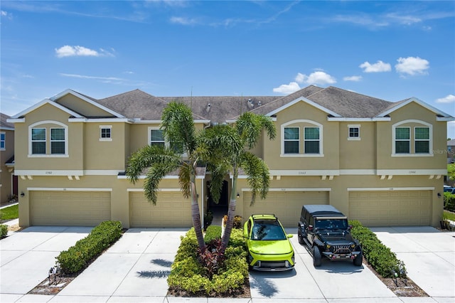 11562 84th Street Cir E Unit 103, Parrish, FL 34219 - traditional home featuring stucco siding, a garage, and driveway