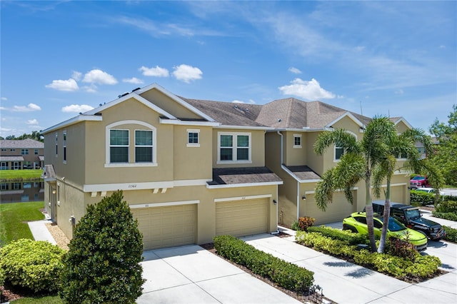 11562 84th Street Cir E Unit 103, Parrish, FL 34219 - traditional home with stucco siding, driveway, and an attached garage