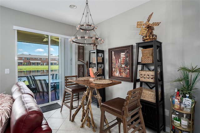 11562 84th Street Cir E Unit 103, Parrish, FL 34219 - dining area featuring a chandelier, light tile patterned flooring, and a water view