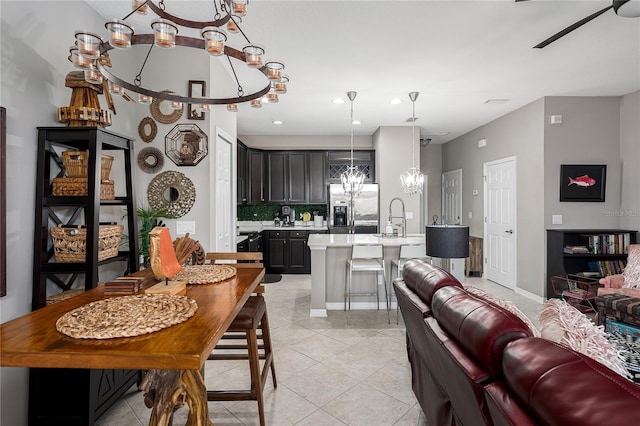 11562 84th Street Cir E Unit 103, Parrish, FL 34219 - kitchen with a chandelier, stainless steel fridge, open floor plan, light countertops, and recessed lighting