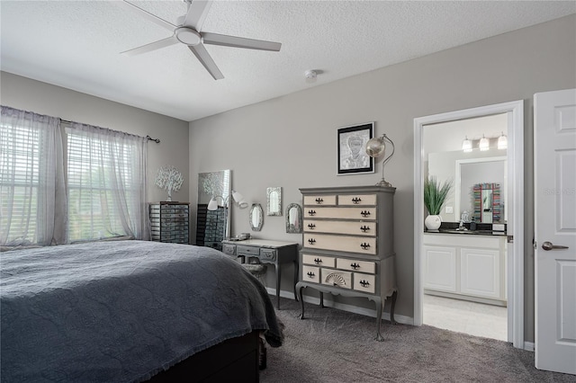 11562 84th Street Cir E Unit 103, Parrish, FL 34219 - bedroom with light colored carpet, a textured ceiling, ensuite bathroom, and a ceiling fan