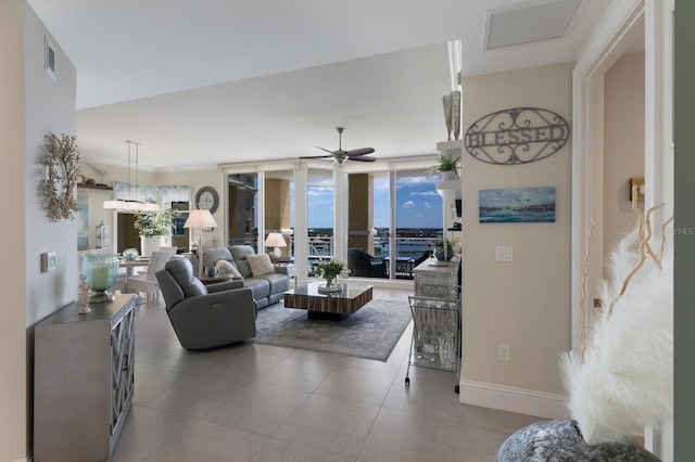 130 Riviera Dunes Way Unit 601, Palmetto, FL 34221 - tiled living area featuring a ceiling fan and baseboards
