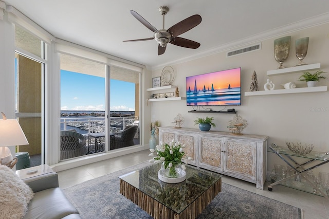 130 Riviera Dunes Way Unit 601, Palmetto, FL 34221 - living area featuring a ceiling fan, crown molding, and tile patterned floors