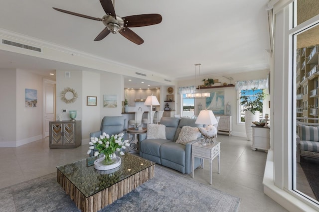 130 Riviera Dunes Way Unit 601, Palmetto, FL 34221 - living room featuring a ceiling fan, tile patterned flooring, and ornamental molding