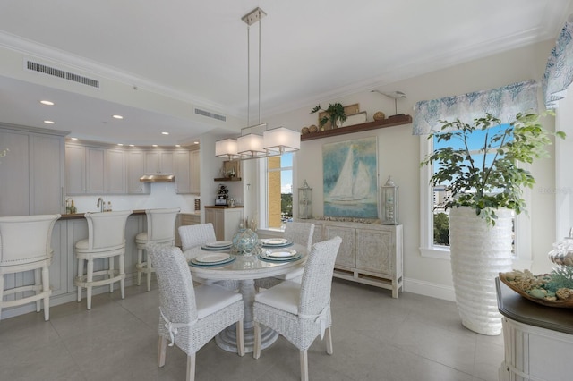 130 Riviera Dunes Way Unit 601, Palmetto, FL 34221 - dining area with healthy amount of natural light, ornamental molding, light tile patterned floors, and recessed lighting