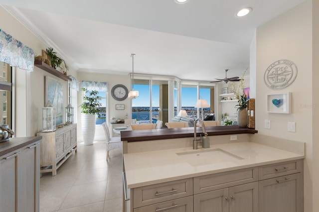 130 Riviera Dunes Way Unit 601, Palmetto, FL 34221 - kitchen featuring ceiling fan, open floor plan, hanging light fixtures, a peninsula, and ornamental molding