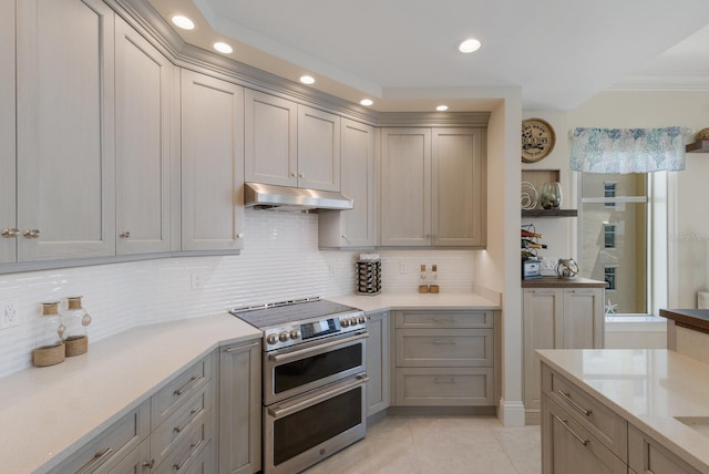 130 Riviera Dunes Way Unit 601, Palmetto, FL 34221 - kitchen featuring range with two ovens, gray cabinetry, recessed lighting, decorative backsplash, and light tile patterned floors