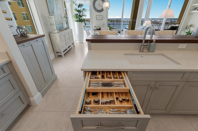 130 Riviera Dunes Way Unit 601, Palmetto, FL 34221 - kitchen with gray cabinets and light tile patterned floors