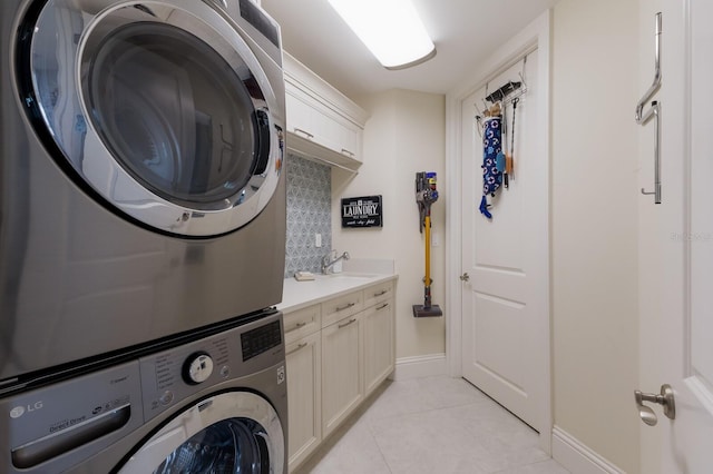 130 Riviera Dunes Way Unit 601, Palmetto, FL 34221 - laundry area with cabinet space, stacked washer / dryer, and light tile patterned floors