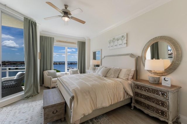 130 Riviera Dunes Way Unit 601, Palmetto, FL 34221 - bedroom with wood finished floors, a water view, a ceiling fan, crown molding, and access to outside