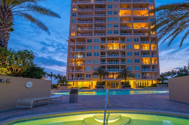 130 Riviera Dunes Way Unit 601, Palmetto, FL 34221 - pool at dusk with a community pool and a patio area