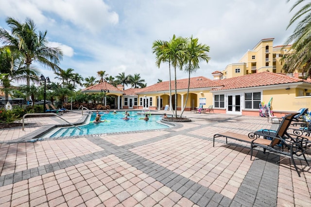 130 Riviera Dunes Way Unit 601, Palmetto, FL 34221 - community pool featuring french doors and a patio