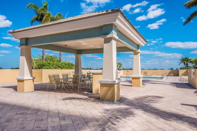 130 Riviera Dunes Way Unit 601, Palmetto, FL 34221 - fenced backyard featuring a community pool, a gazebo, and outdoor dining space