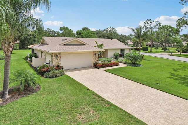 5283 Everwood Run, Sarasota, FL 34235 - ranch-style house with stone siding, an attached garage, decorative driveway, and a front yard