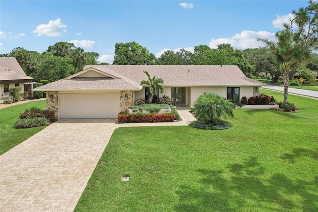 5283 Everwood Run, Sarasota, FL 34235 - single story home with a garage, decorative driveway, stone siding, a front yard, and stucco siding