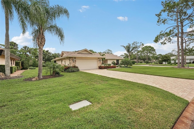 5283 Everwood Run, Sarasota, FL 34235 - ranch-style home with a front lawn, driveway, a garage, and stucco siding