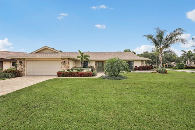 5283 Everwood Run, Sarasota, FL 34235 - ranch-style house with a garage, decorative driveway, a front yard, and stone siding