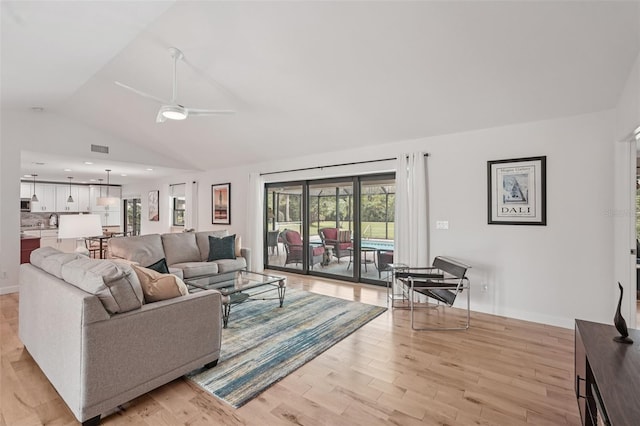 5283 Everwood Run, Sarasota, FL 34235 - living area with vaulted ceiling, a ceiling fan, and light wood-style floors