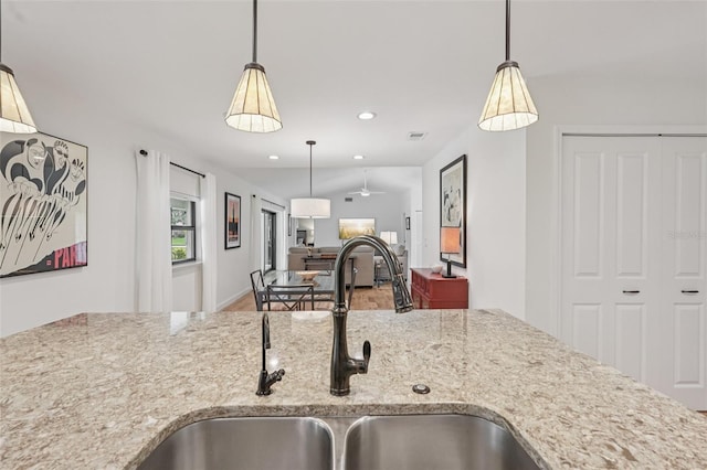 5283 Everwood Run, Sarasota, FL 34235 - kitchen with light stone countertops, pendant lighting, open floor plan, recessed lighting, and ceiling fan