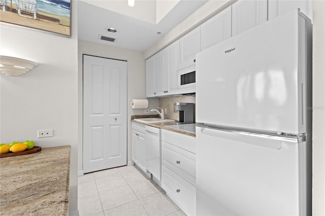 225 Sands Point Rd Unit 6103, Longboat Key, FL 34228 - kitchen featuring white appliances, white cabinetry, light tile patterned floors, light countertops, and recessed lighting