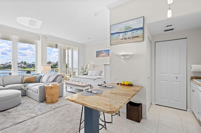 225 Sands Point Rd Unit 6103, Longboat Key, FL 34228 - living room with light tile patterned floors and a water view