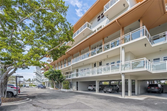 225 Sands Point Rd Unit 6103, Longboat Key, FL 34228 - view of apartment building / complex featuring covered parking
