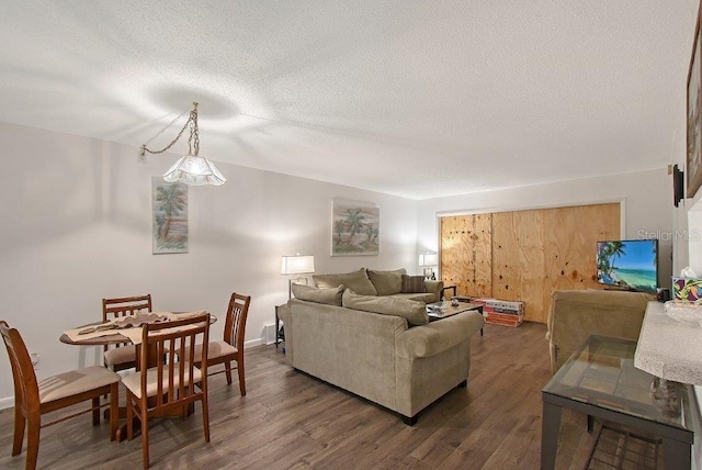 1036 W Peppertree Ln Unit 113B, Sarasota, FL 34242 - living room featuring dark wood finished floors and a textured ceiling