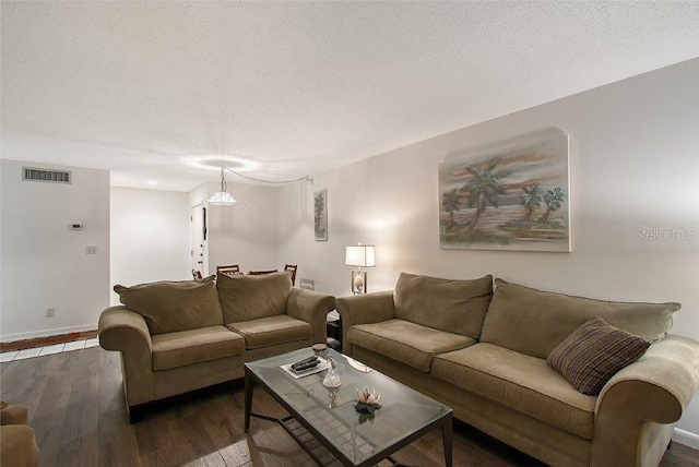 1036 W Peppertree Ln Unit 113B, Sarasota, FL 34242 - living room with a textured ceiling and wood finished floors
