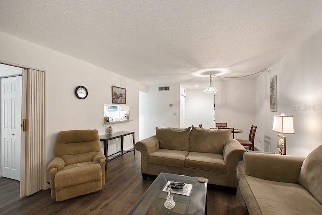 1036 W Peppertree Ln Unit 113B, Sarasota, FL 34242 - living room with dark wood-style floors and a textured ceiling