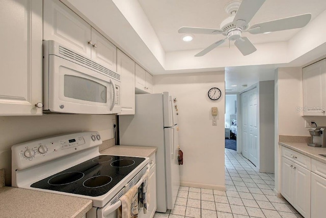 1036 W Peppertree Ln Unit 113B, Sarasota, FL 34242 - kitchen featuring white appliances, light countertops, light tile patterned flooring, white cabinetry, and recessed lighting