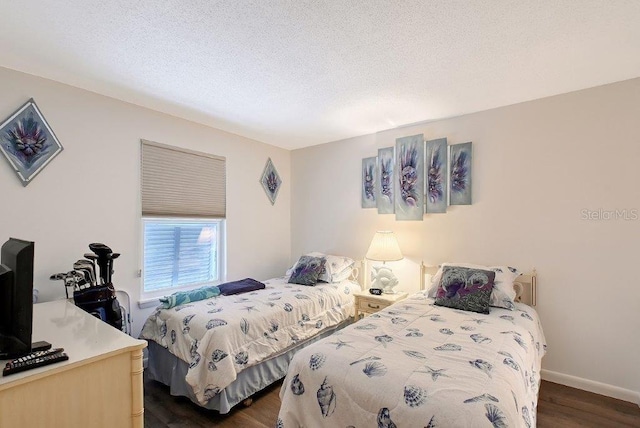 1036 W Peppertree Ln Unit 113B, Sarasota, FL 34242 - bedroom with dark wood-style flooring and a textured ceiling