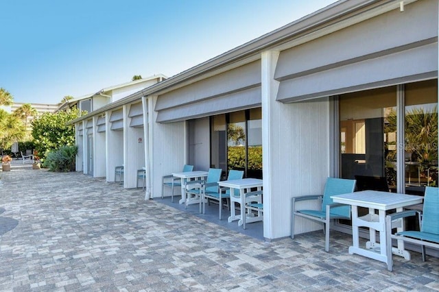 1036 W Peppertree Ln Unit 113B, Sarasota, FL 34242 - view of patio featuring outdoor dining area