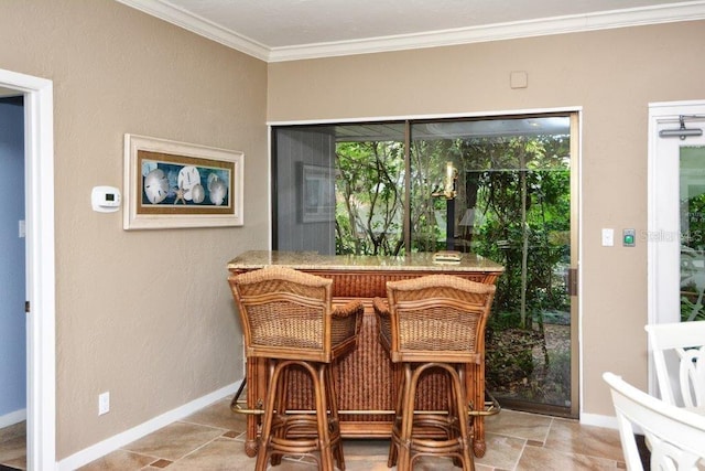 1036 W Peppertree Ln Unit 113B, Sarasota, FL 34242 - dining area featuring bar area, crown molding, and stone finish flooring