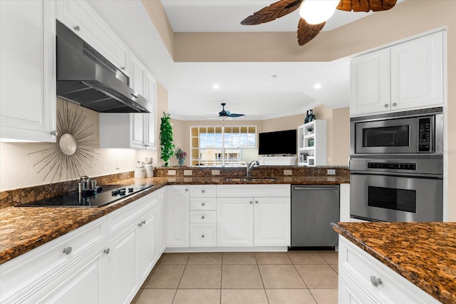 14041 Bellagio Way Unit 414, Osprey, FL 34229 - kitchen featuring appliances with stainless steel finishes, exhaust hood, a ceiling fan, light tile patterned flooring, and white cabinetry