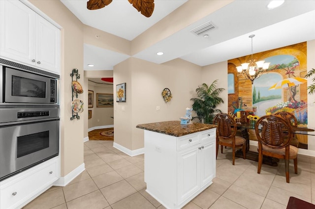14041 Bellagio Way Unit 414, Osprey, FL 34229 - kitchen featuring stainless steel appliances, light tile patterned flooring, white cabinetry, a chandelier, and recessed lighting