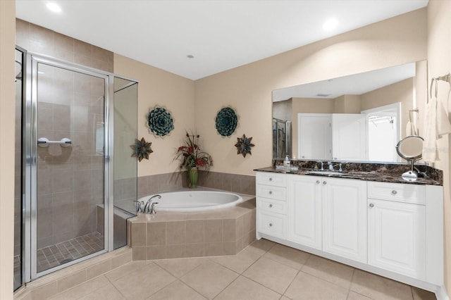 14041 Bellagio Way Unit 414, Osprey, FL 34229 - full bathroom featuring vanity, a bath, a shower stall, tile patterned floors, and recessed lighting