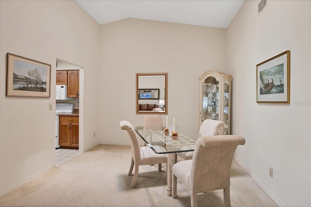 4001 Wilshire Cir E Unit 72, Sarasota, FL 34238 - dining room featuring light colored carpet and high vaulted ceiling