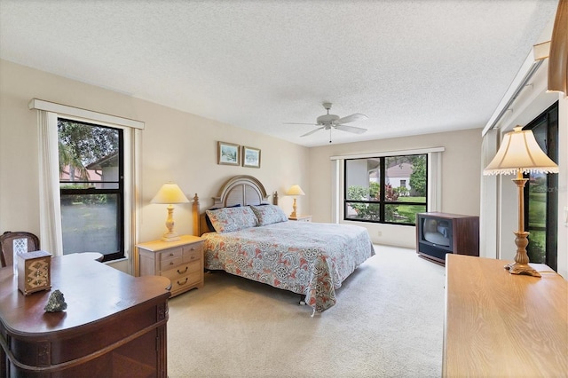 4001 Wilshire Cir E Unit 72, Sarasota, FL 34238 - bedroom with light colored carpet, a textured ceiling, and ceiling fan