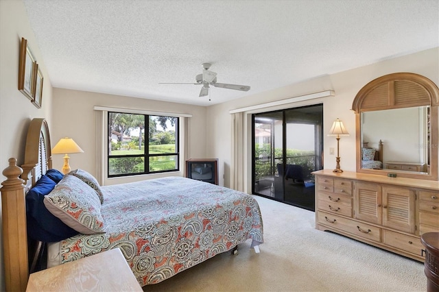 4001 Wilshire Cir E Unit 72, Sarasota, FL 34238 - carpeted bedroom with access to exterior, a textured ceiling, and ceiling fan
