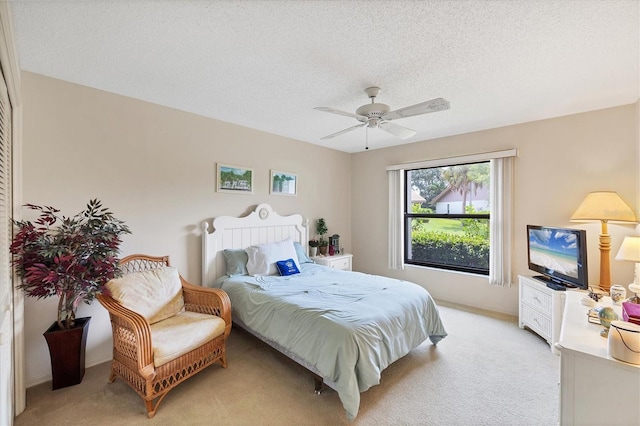 4001 Wilshire Cir E Unit 72, Sarasota, FL 34238 - bedroom featuring light carpet, a textured ceiling, and ceiling fan