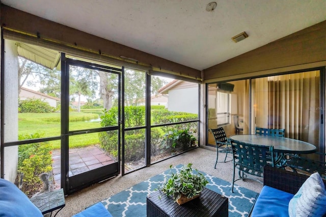 4001 Wilshire Cir E Unit 72, Sarasota, FL 34238 - sunroom / solarium with lofted ceiling and outdoor dining space